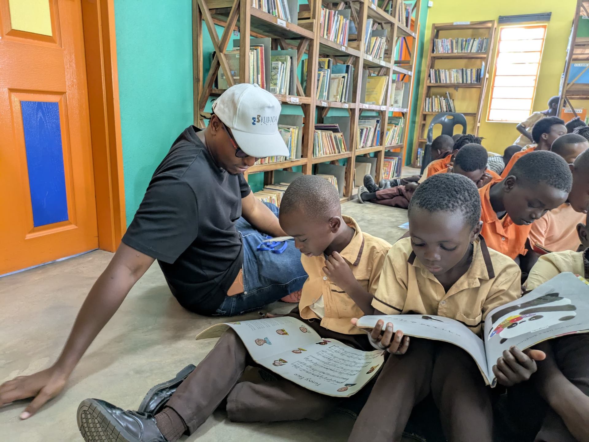 Reading together in a community library at Impact One Initiative - Lusaka